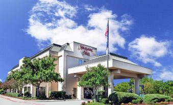 "a large hotel building with a sign that reads "" hampton inn "" prominently displayed on the front" at Grayson Manor