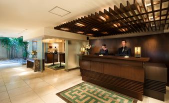 The hotel lobby features an open concept design with a front desk and reception area at Oakwood Apartments Roppongi Central