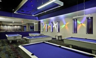 a pool hall with multiple blue and white pool tables , multiple chairs , and a billiard room at Costa Bahia Hotel, Convention Center and Casino