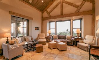 a spacious living room with multiple couches and chairs arranged in a lounge area , creating a cozy atmosphere at Rosewood Cape Kidnappers