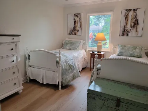Golf cart distance to WEF! Charming 3 bedroom waterfront home with heated pool.