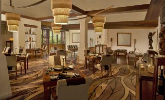 a dining room with several tables and chairs arranged for a group of people to enjoy a meal together at Anantara Hua Hin Resort