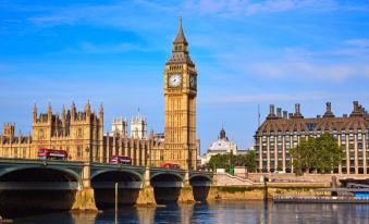 a beautiful view of the big ben clock tower and westminster palace , with the thames river in the foreground at Ibis London Greenwich