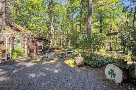 Rustic Rest Log Cabin, with hot tub and trout stream, near Poconos attractions.