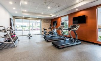 a gym with treadmills , stationary bikes , and other exercise equipment , as well as a television mounted on the wall at Home2 Suites by Hilton Fort Worth  Northlake