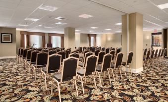 a large conference room with rows of chairs arranged in a semicircle , ready for a meeting or event at Homewood Suites by Hilton Newtown - Langhorne