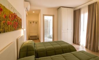 a bedroom with two beds , one on the left and one on the right side of the room at Hotel Royal