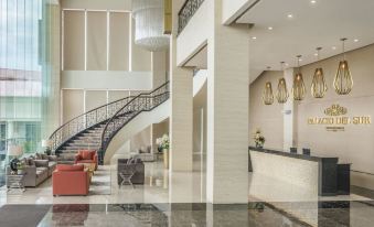 a grand lobby with a staircase , seating area , and chandeliers , as well as a reception desk and a large window at Marcian Garden Hotel