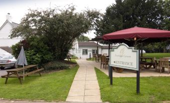 a large outdoor dining area with several tables and chairs , as well as an entrance sign for the pavilion eatery at Taunton Ruishton (M5, J25)