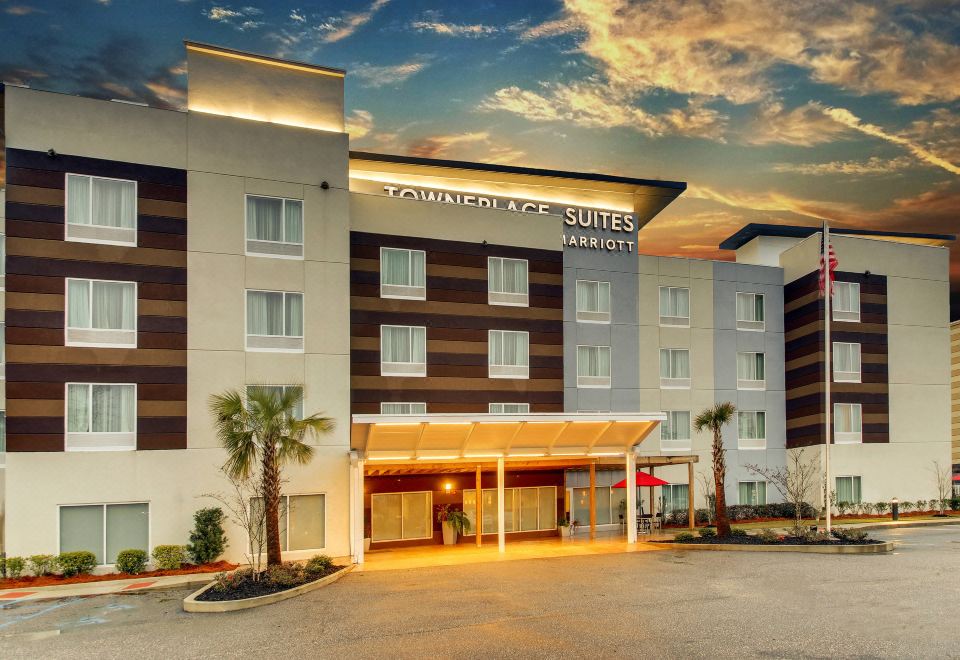 "a large hotel with a sign that reads "" the comfort suites "" prominently displayed on the front of the building" at TownePlace Suites Mobile Saraland