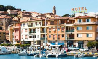 a picturesque view of a small town by the water , with numerous boats docked in the harbor at Hotel L'Approdo