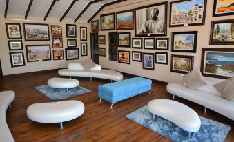 a room with a variety of seating options , including couches and chairs , arranged around a coffee table at Balmoral Lodge