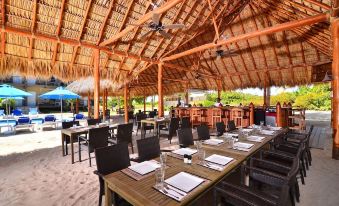 a large wooden dining area with tables and chairs set up for a party or event at Anegada Beach Club