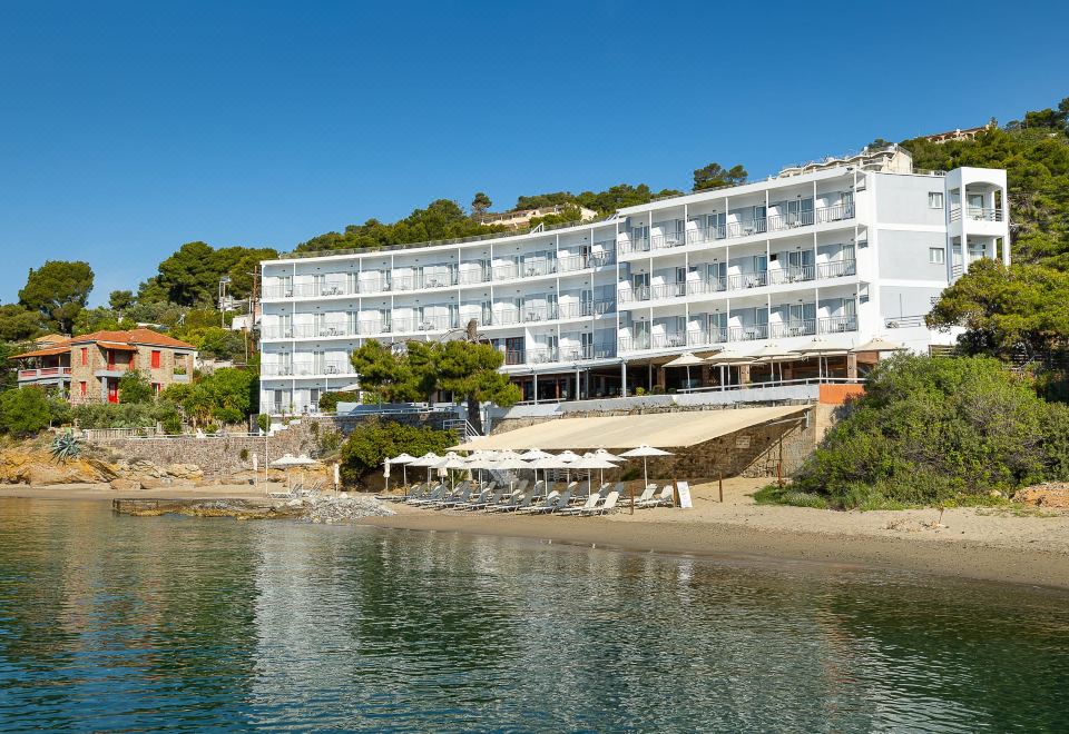 a large white hotel building situated on the side of a hill , overlooking a body of water at Golden View