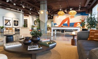 a modern living room with various furniture , including a couch , chairs , and a coffee table at Wave Resort