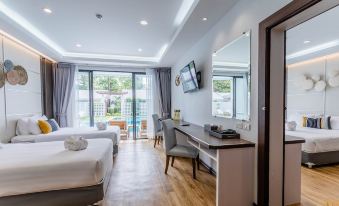 a modern hotel room with a wooden floor , white bed , and desk , along with a balcony view through the window at Chaolao Cabana Resort