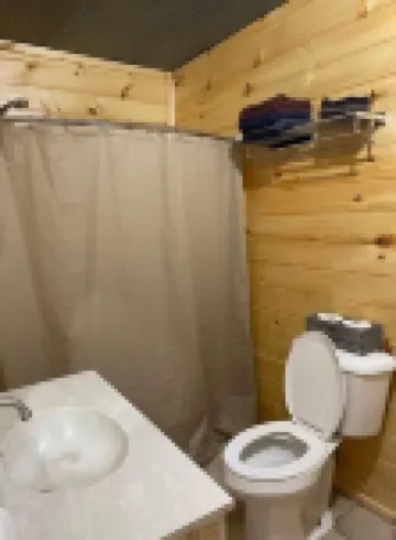 2BR 1 Bath cabin w/ full kitchen, hot tub, and living room.