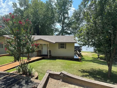 Peaceful lake front home with wrap around porch and relaxing views!
