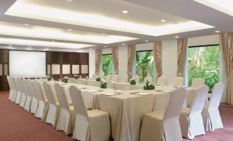 a large , empty conference room with white chairs and tables set up for a meeting or event at Anantara Hua Hin Resort