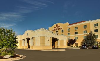 a large hotel building with a red roof , situated in front of a parking lot at The Inn at Charles Town / Hollywood Casino