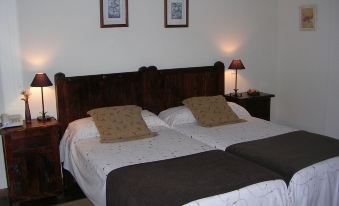 a hotel room with two beds , one on the left and one on the right side of the room at El Castro