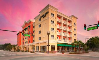 "a large building with a sign that says "" courtyard suites "" is shown in the image" at Courtyard DeLand Historic Downtown