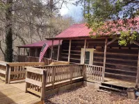 Authentic log cabin nestled in the woods by creek