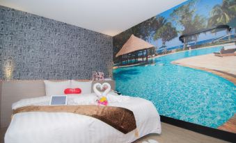 a cozy bedroom with a large bed and a mural of a swimming pool on the wall at 101 Hotel