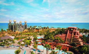 a beautiful resort with a pool and a view of the ocean , surrounded by palm trees at The Royal at Atlantis