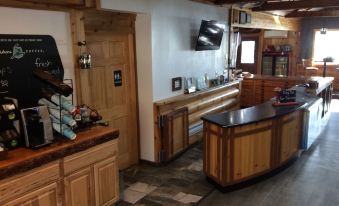 a room with wooden cabinets and a curved counter , featuring a television mounted on the wall at Kohl's Resort