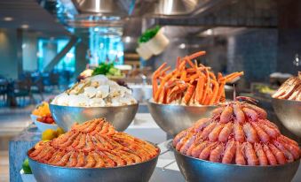 A table is adorned with numerous bowls and dishes placed on the countertop at Hangzhou Marriott Hotel Qianjiang