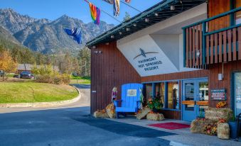 a building with a blue mailbox on the front and colorful flags hanging from the eaves at Fairmont Hot Springs Resort