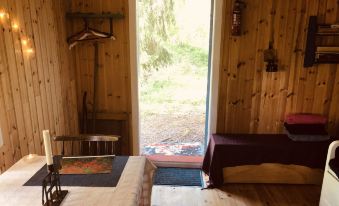 Tiny Hut in the Forest Overlooking the River