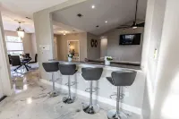 Enjoy this waterfront home with a pool, dock, and Blue Angels! Bring your boat!