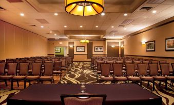 a large conference room with rows of chairs arranged in a semicircle , ready for an event at Best Western Plus North Haven Hotel