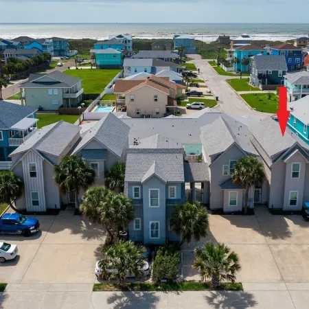 In-town coastal getaway, with a heated pool & level 2 Tesla EV charger on site.
