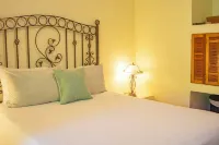 Private suite 102 with beautiful gardens, shared pool and BBQ area!