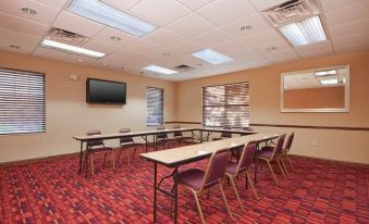 a large conference room with multiple tables and chairs arranged for a meeting or event at Residence Inn West Springfield