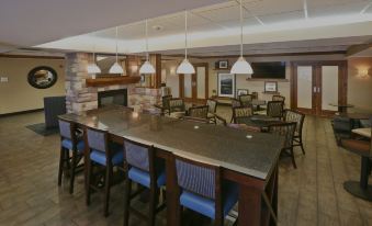 a large dining room with multiple tables and chairs arranged for a group of people to enjoy a meal together at Hampton Inn Billings