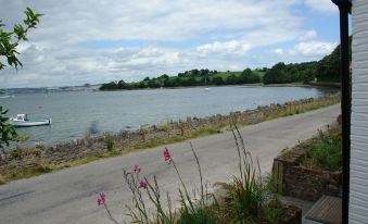 a paved road leading to a body of water , possibly a lake or a river at Lakeside