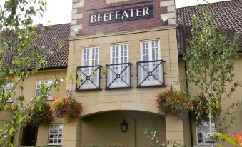 "a large building with a sign that reads "" beefeater "" prominently displayed on the front of the building" at Premier Inn Bristol East (Emersons Green)
