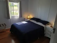 Indoor/outdoor pet-friendly beach house next to world-class beach and river.