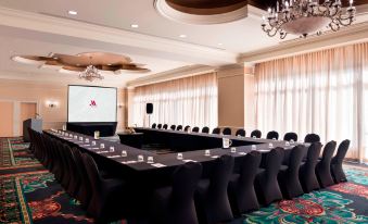 a large conference room with a long table and multiple chairs arranged for a meeting at St. Kitts Marriott Resort & the Royal Beach Casino