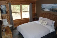 Secluded modern log cabin with picturesque private water fall on 12 acres!