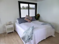 Vaka Beach Retreat- modern air conditioned apartment & steps to Vaimaanga Beach!