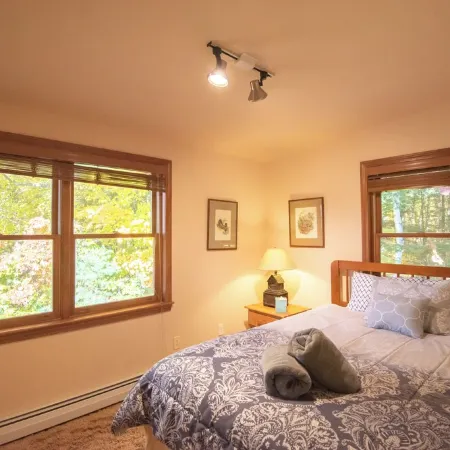 Stunning lakefront home with a boathouse, private dock, firepit and lake views