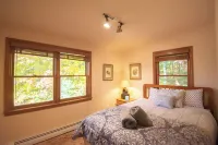 Stunning lakefront home with a boathouse, private dock, firepit and lake views