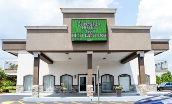 the surestay hotel by best western hotel sign is displayed above the entrance , with a car parked nearby at SureStay Hotel by Best Western Bowling Green North