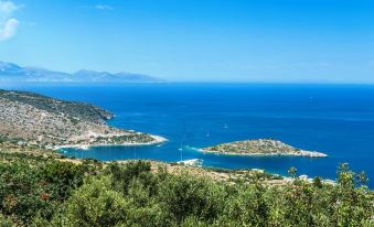 a beautiful view of a coastal town with boats in the water , surrounded by lush green trees and blue skies at Emerald Villas & Suites - the Finest Hotels of the World