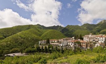 a small village nestled in a mountainous landscape , with a large group of people gathered around it at Hotel Scapolatiello